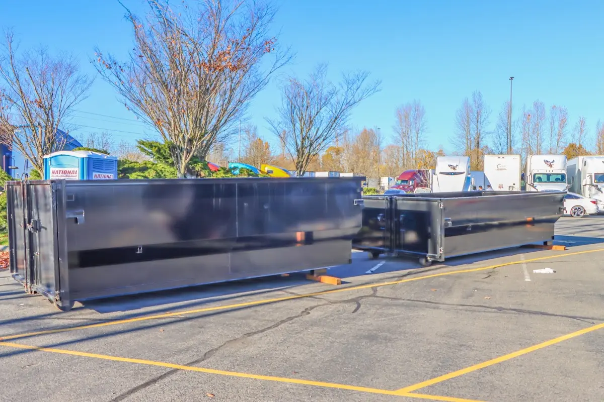 Professional dumpster rental service with roll-off container on residential driveway in Harwood Heights